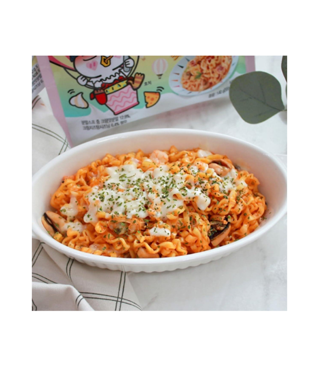 Bowl of Samyang Buldak Cream Carbonara-style spicy noodles with creamy topping