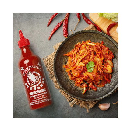 Flying Goose Sriracha Kimchi Sauce bottle beside bowl of spicy kimchi