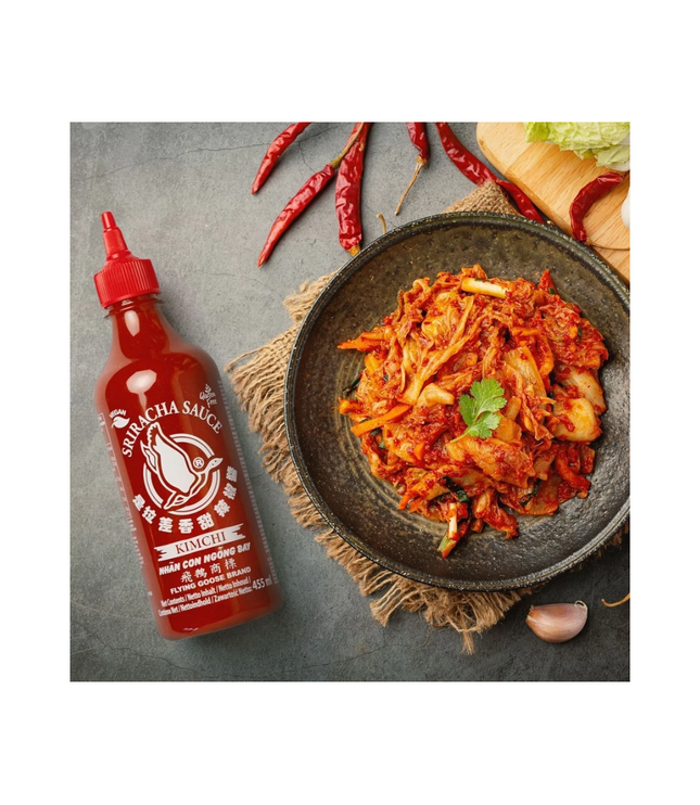 Flying Goose Sriracha Kimchi Sauce bottle beside bowl of spicy kimchi
